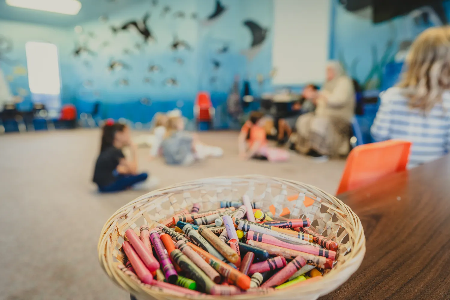 A basket of crayons in a children's classroom