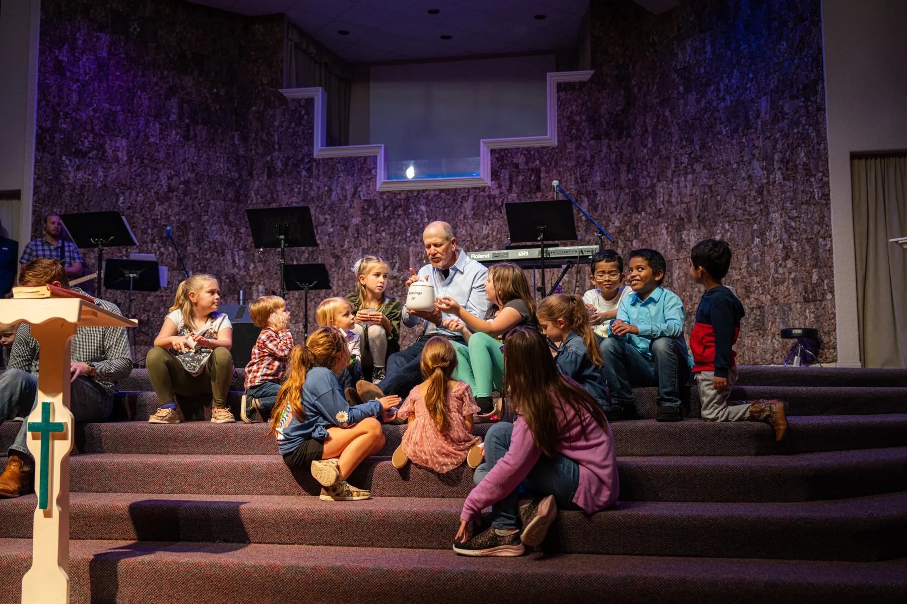 Children gathered on the stage for the children's sermon