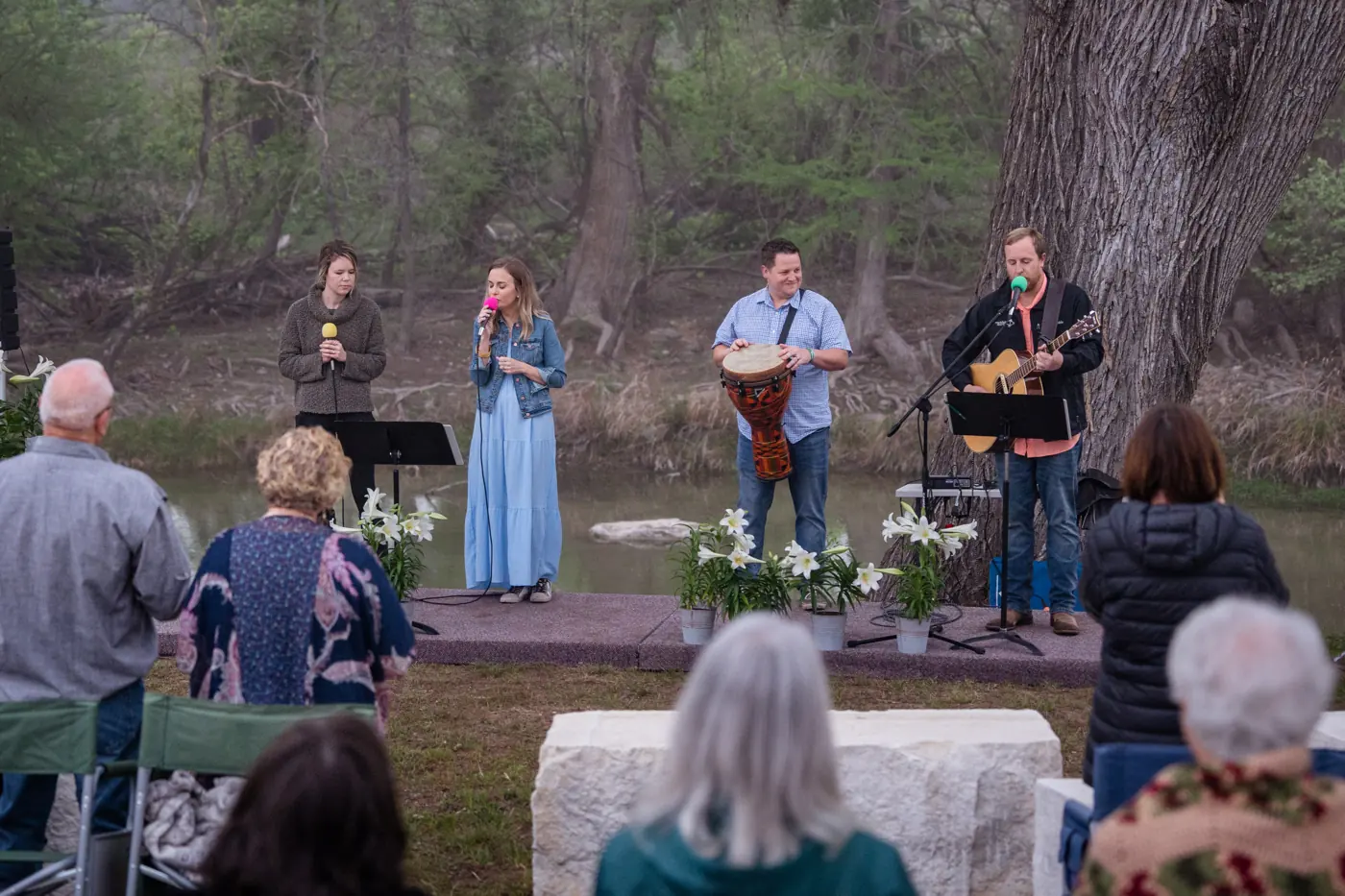 The worship band leading songs outdoors at sunrise